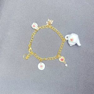 Tea time stainless steel gold charm bracelet